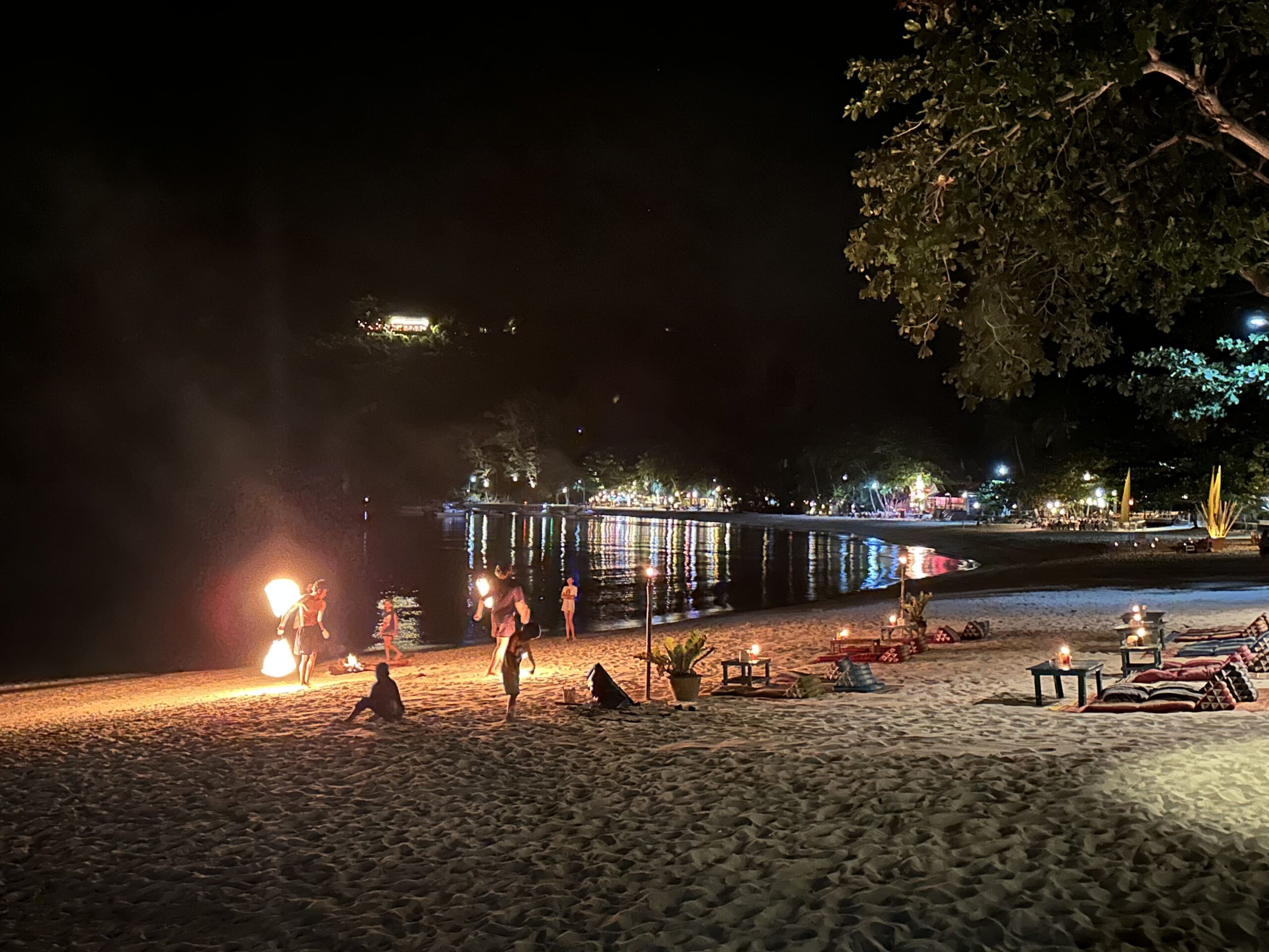 2 Männer führen eine Feuershow am Strand auf